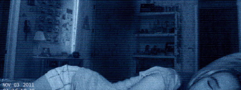 Paranormal Activity 4 movie review image showing blue tinted surveillance footage of a bedroom
