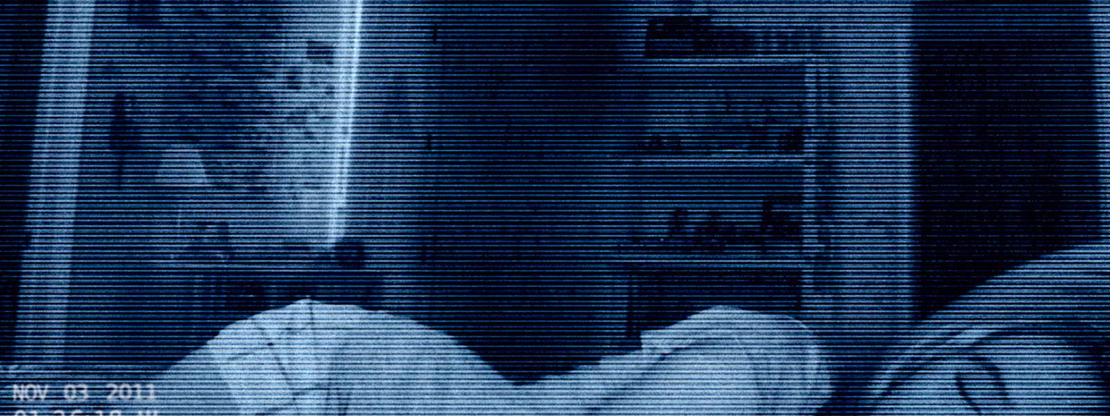 Paranormal Activity 4 movie review image showing blue tinted surveillance footage of a bedroom